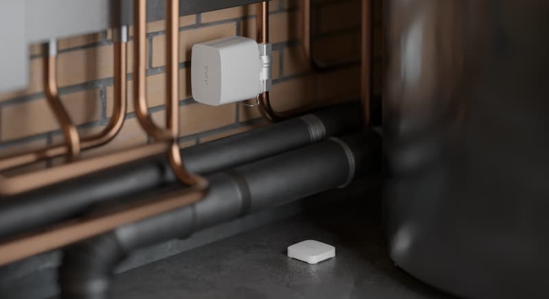 Ajax water leak detector installed near home plumbing to prevent flood damage with environmental monitoring