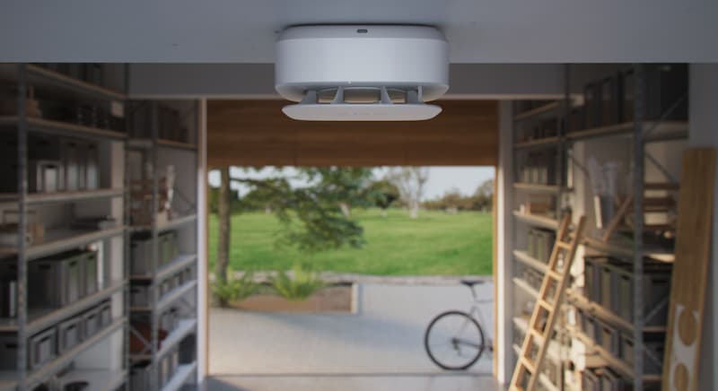 Ajax smoke and heat detector installed in a residential storage space for fire and carbon monoxide safety monitoring