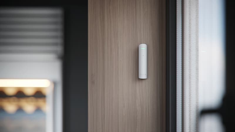 Ajax glass break detector mounted on wall to detect window break and intrusion attempts