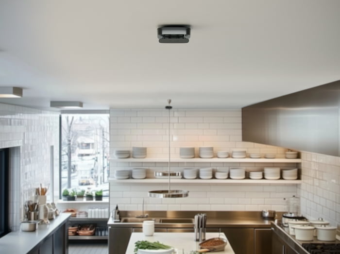 Ajax FireProtect 2 smoke and heat detector on a restaurant kitchen ceiling — commercial kitchen fire detection in Houston