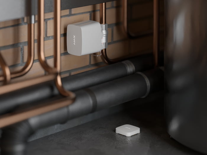 Ajax LeaksProtect leak detector and WaterStop shutoff valve in a restaurant utility area — water leak and equipment protection for Houston restaurants