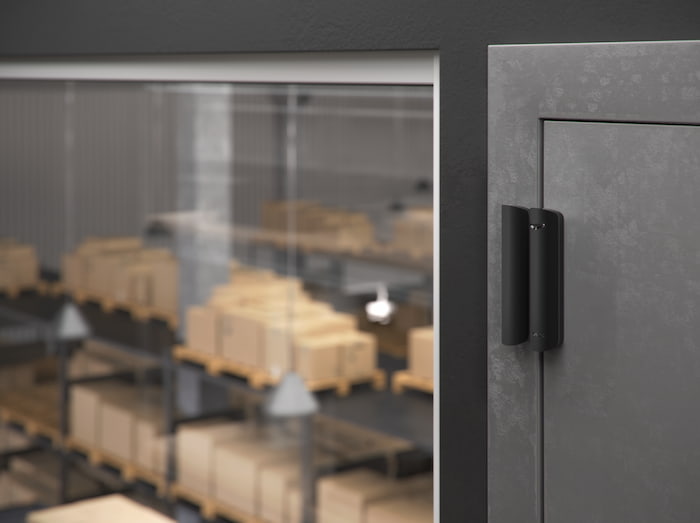 Ajax door opening detector installed on a staff entrance inside a warehouse