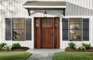 Exterior of a home with a wood door.