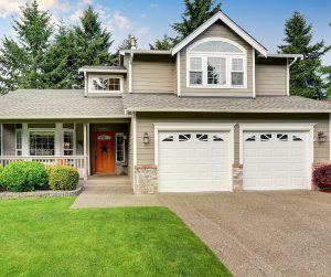 Curbside view of off-gray house with new windows