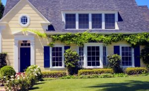 Yellow suburban home with white framed windows