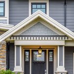 Front of home with grey siding and white roofing