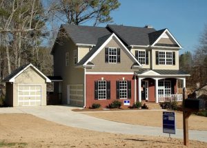 Suburban home with detached garage and gray roof