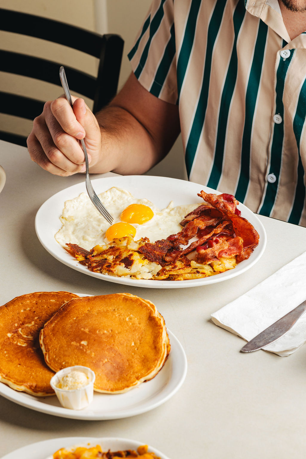 bacon and eggs from the silver grill on a plate.