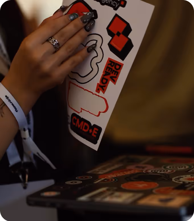 Open menu with a green page listing vitamin juices and prices in Serbian, next to a cartoon black fox wearing red boots holding a glass, on a wooden table with a person's hand nearby.