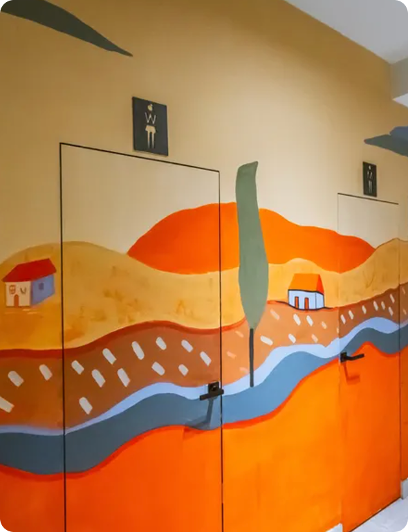 Person using a stylus to draw a digital illustration on a tablet with the word 'ANXIES' and abstract shapes.