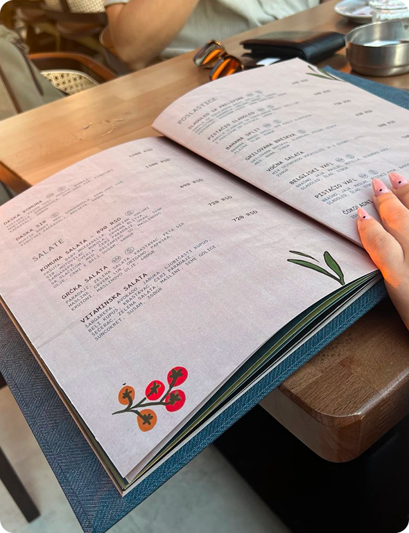 Black and white dog sitting next to a package labeled 'ANXIES' with a cartoon dog illustration and text about supplementation for anxious pups with marijuana.