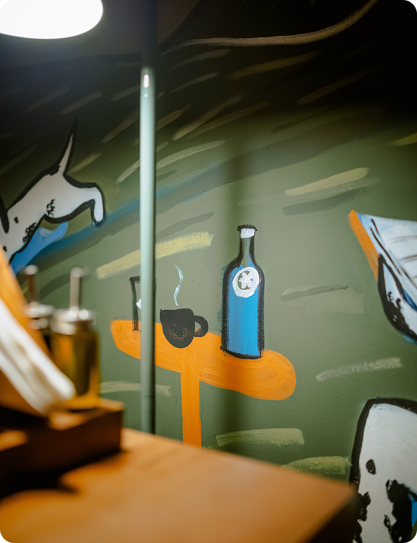 Black and white dog sitting next to a package labeled 'ANXIES' with a cartoon dog illustration and text about supplementation for anxious pups with marijuana.