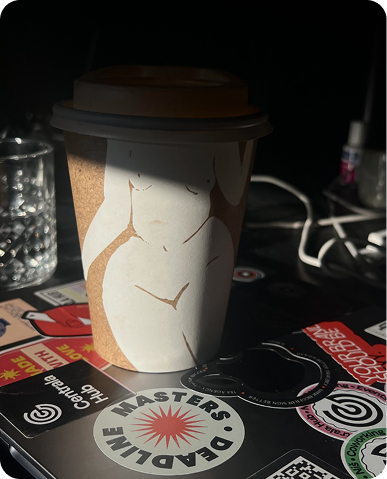 Person using a stylus to draw a digital illustration on a tablet with the word 'ANXIES' and abstract shapes.