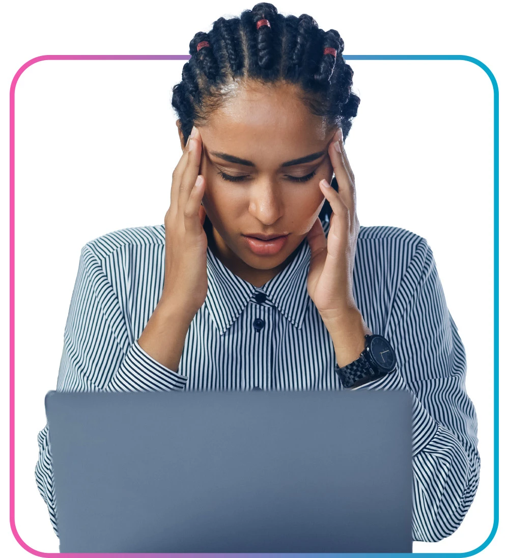 Woman caressing head while looking at a laptop, stressed