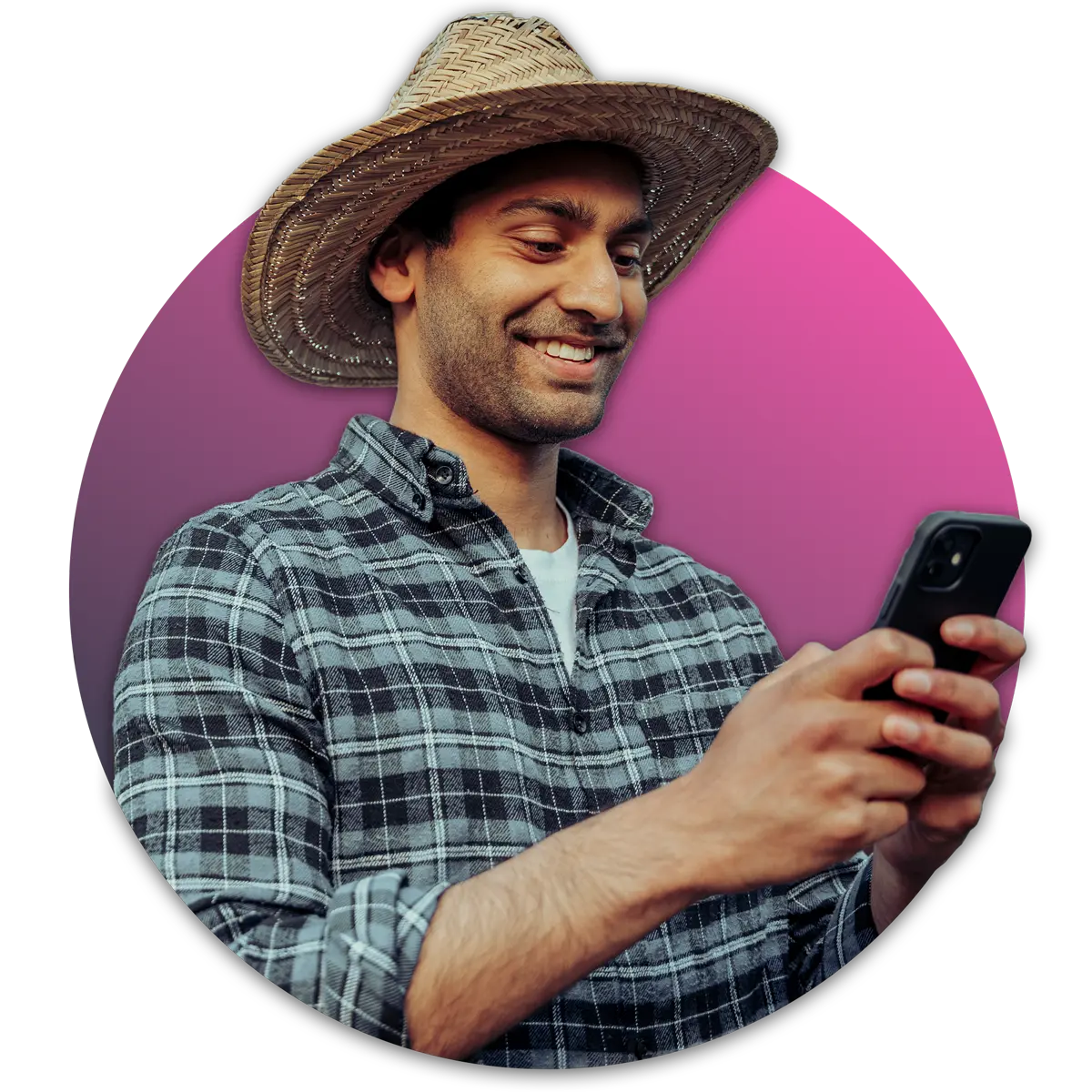 man in straw hat typing on cell phone and smiling