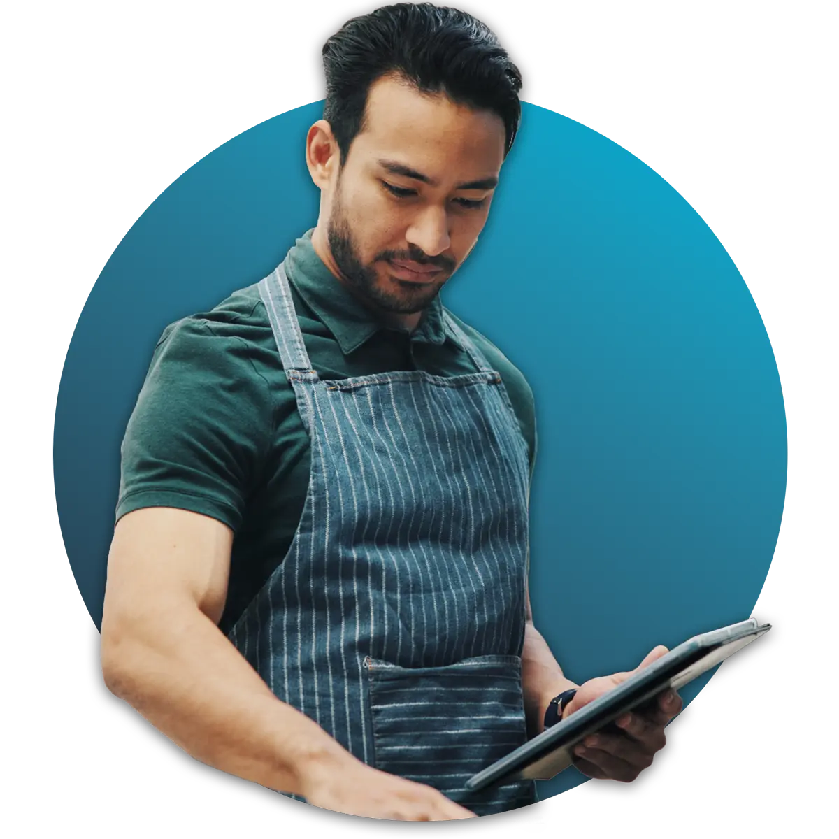 Man wearing apron holding a tablet looking down