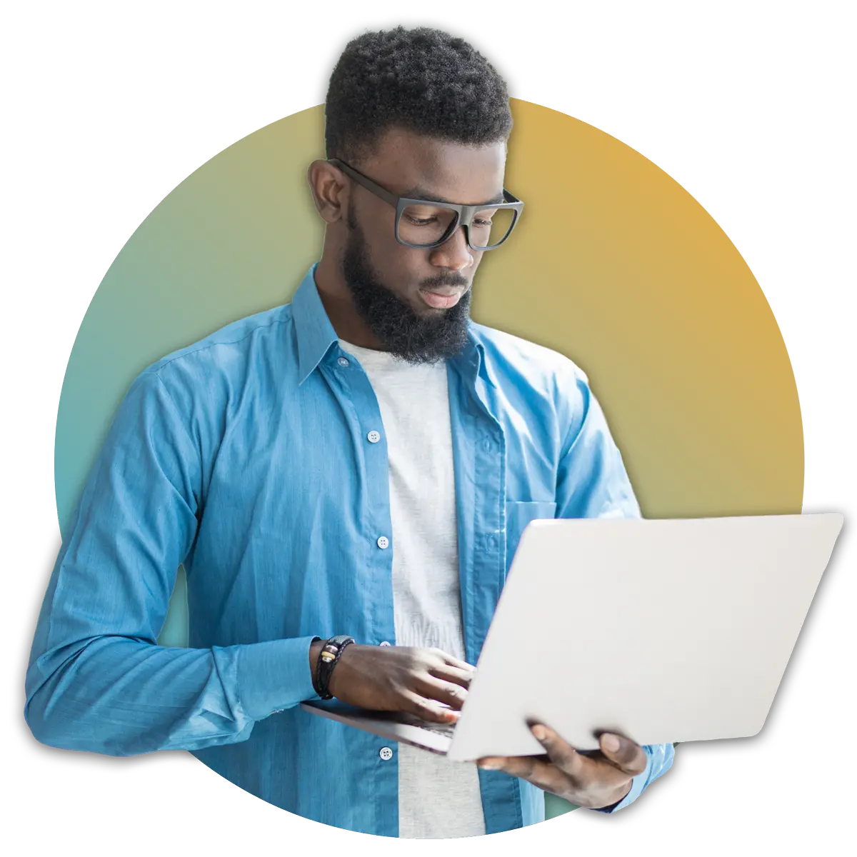 man in blue button down shirt looking down at laptop in hand