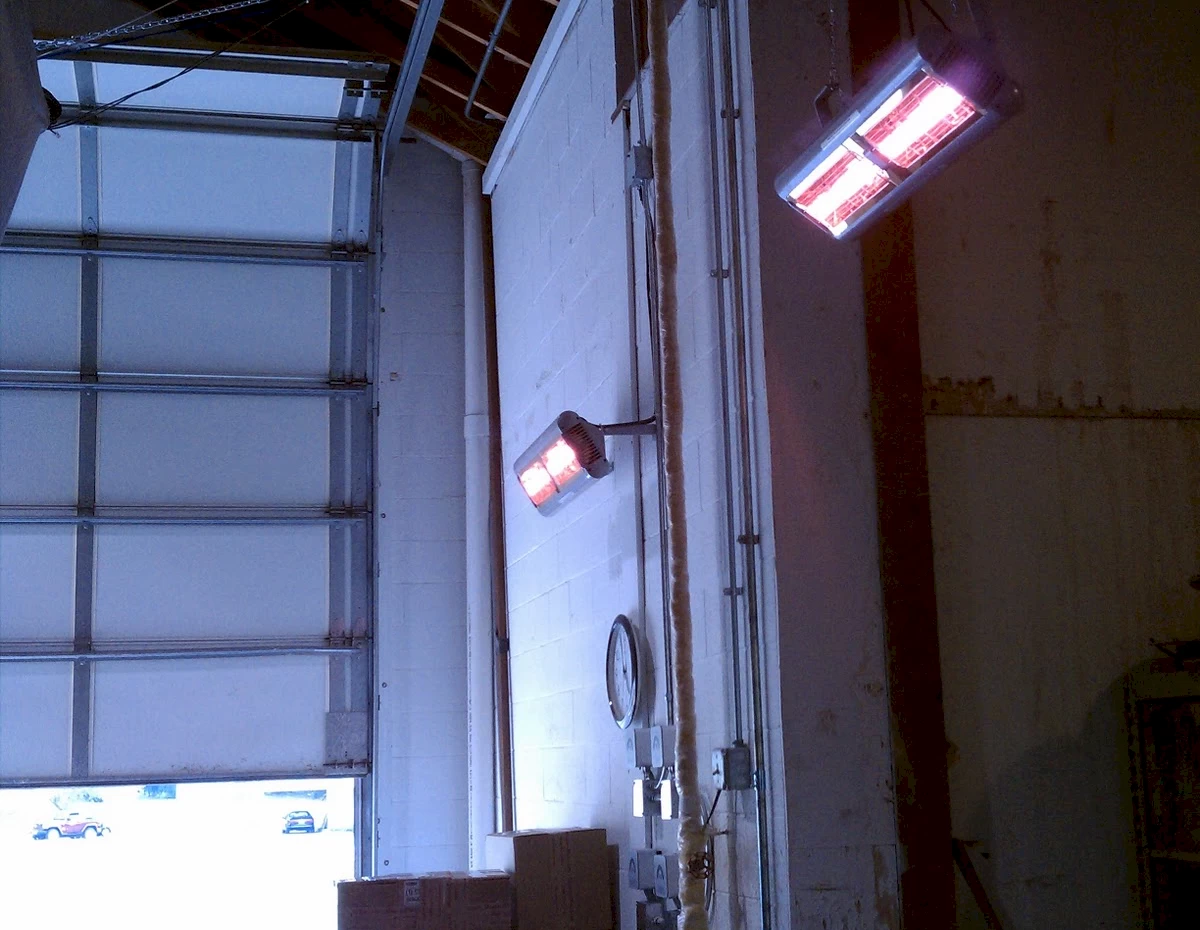 Three large gray Generac industrial power units numbered 1, 2, and 3 outdoors surrounded by trees.