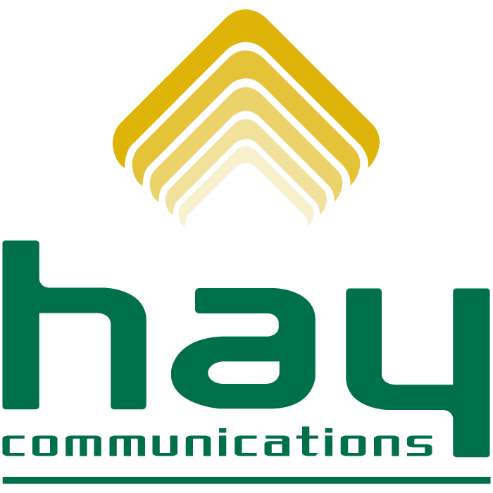 Hay Communications logo with stylized golden layered chevron shapes above the green lowercase word 'hay' and smaller text 'communications' below.