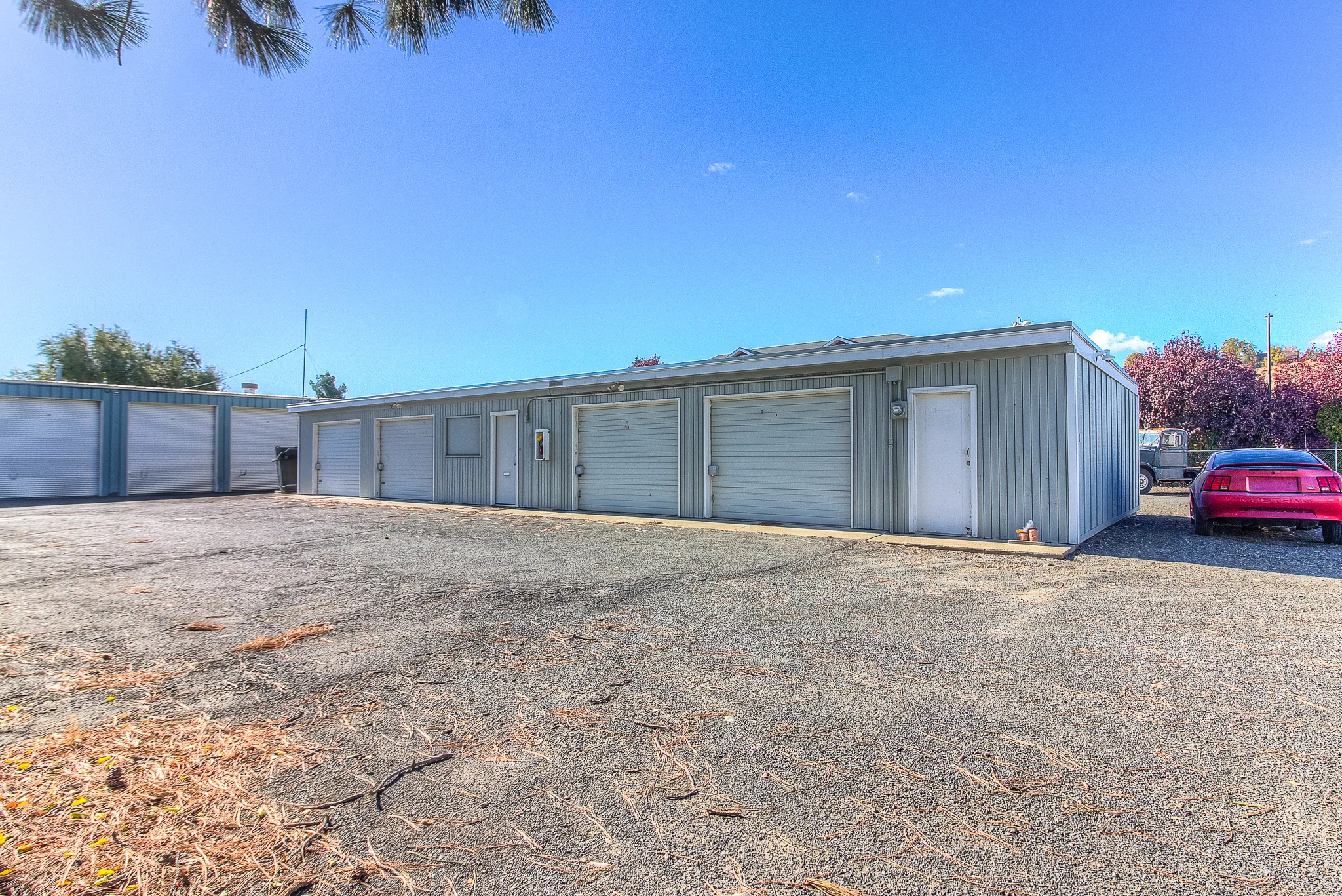 Security 1st Storage, 34th Avenue, showing compact garage-style units in open lot with clear sky, professional and secure storage environment.