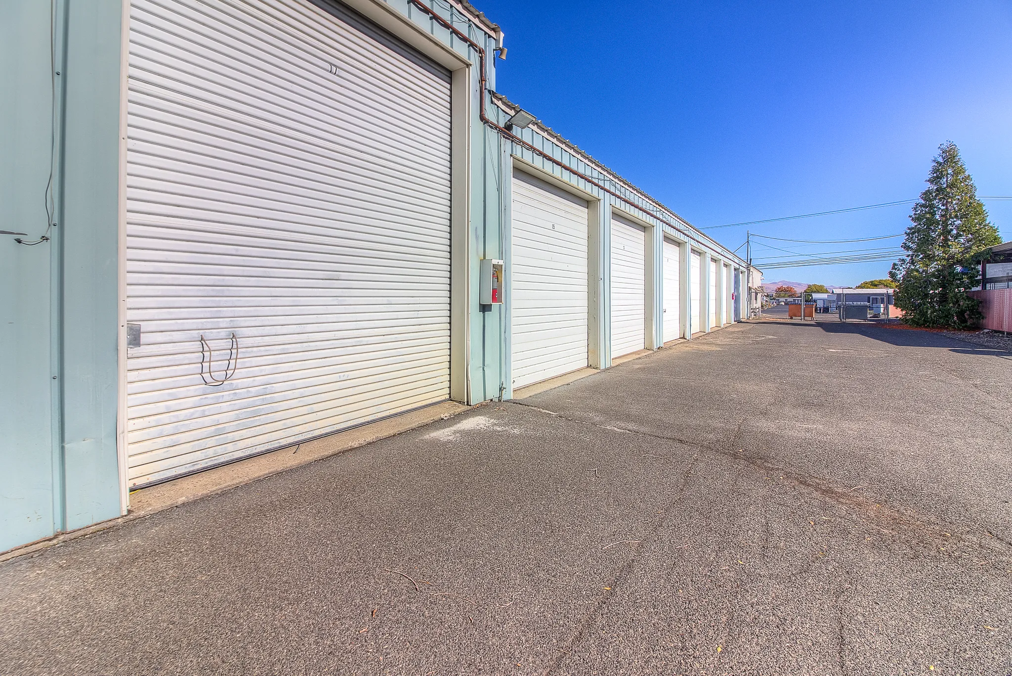 Row of white steel storage unit doors at Security 1st Storage, 34th Avenue, showing secure, clean, and well-maintained drive-up access.