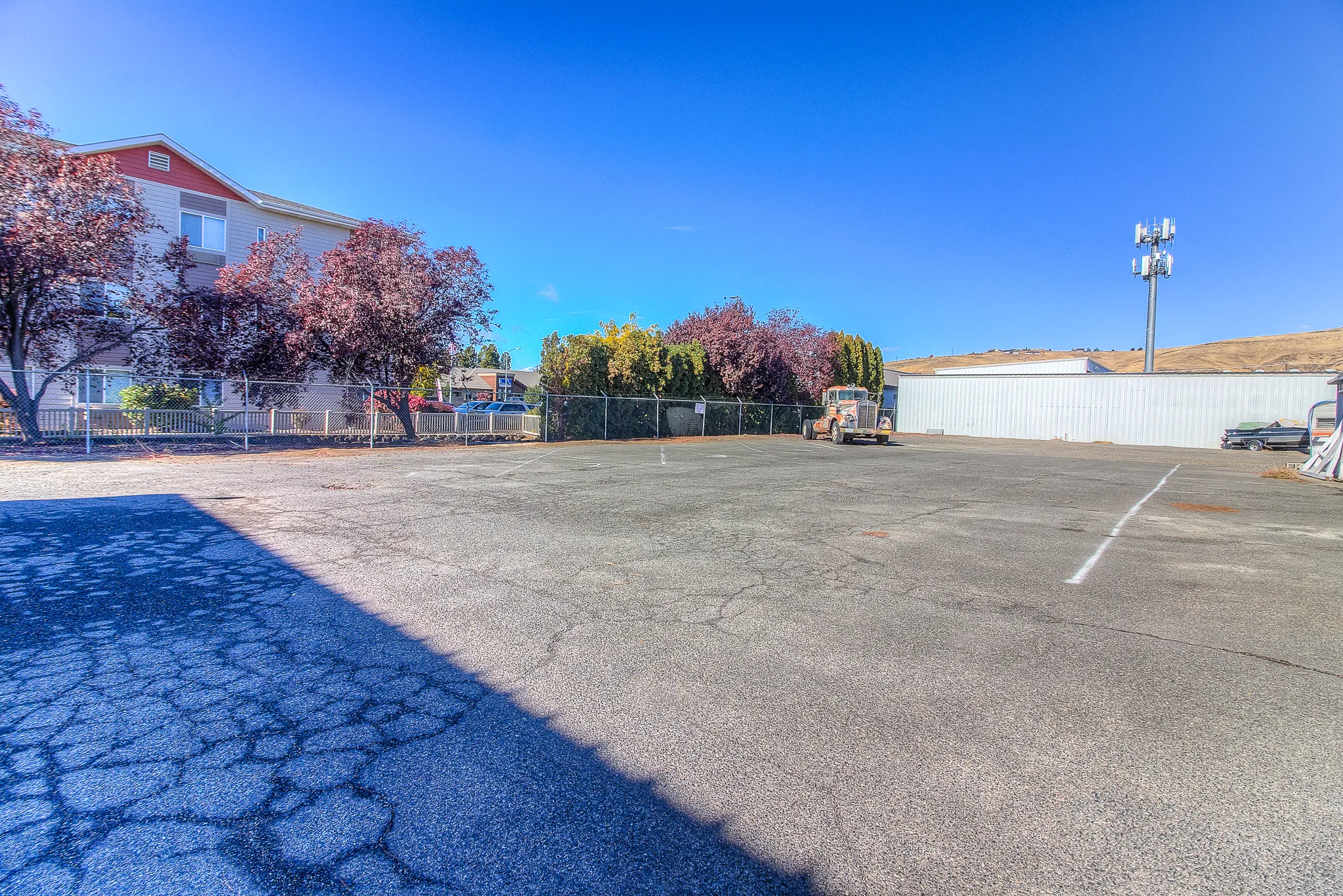 Open parking area at Security 1st Storage, 34th Avenue, enclosed with fencing and surrounded by trees for added privacy and security.