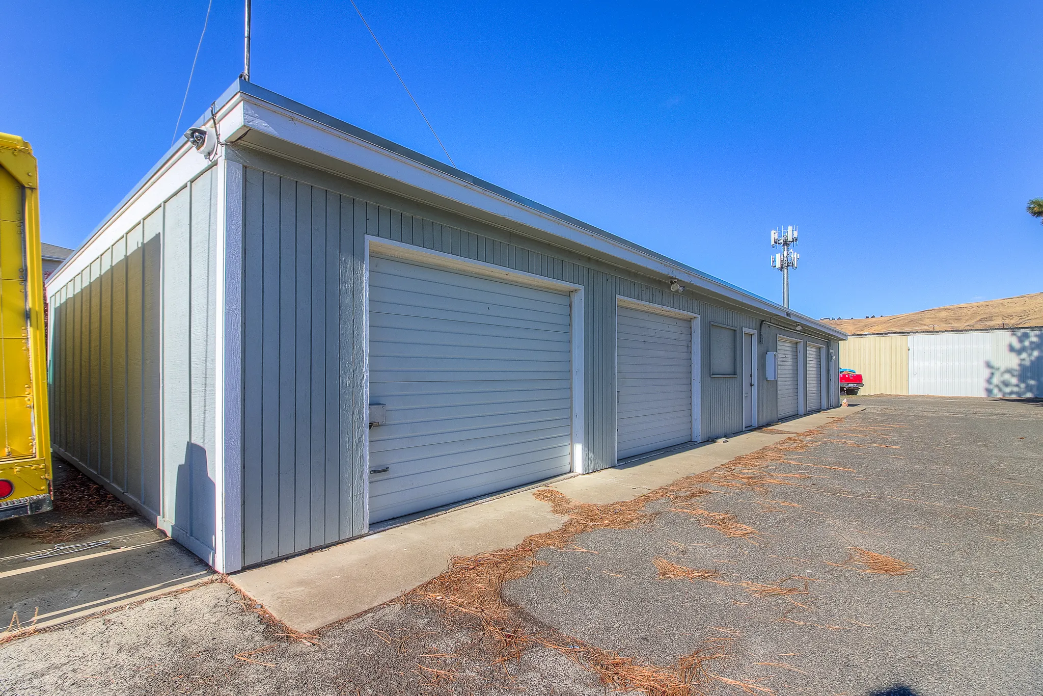 Side view of secure storage units at Security 1st Storage, 34th Avenue, durable steel roll-up doors and camera-equipped facility.