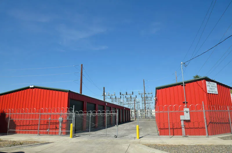Main entrance to Security 1st Storage, Pacific Avenue, gated access and perimeter fencing enclosing two buildings.