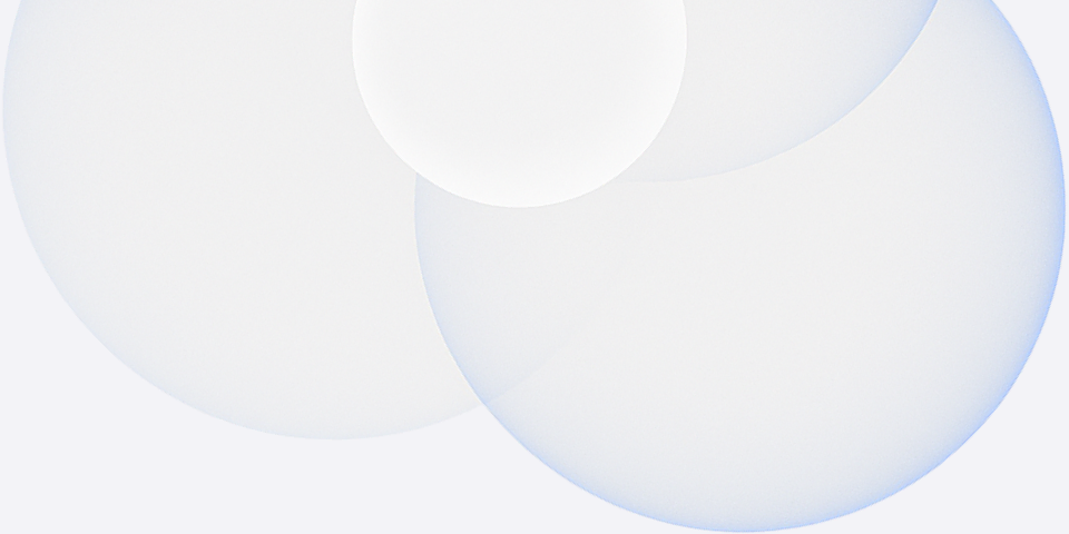 Three overlapping translucent circles in a Venn diagram arrangement with soft lavender-blue edges and a bright white center where all three intersect, set against a pale gray background.