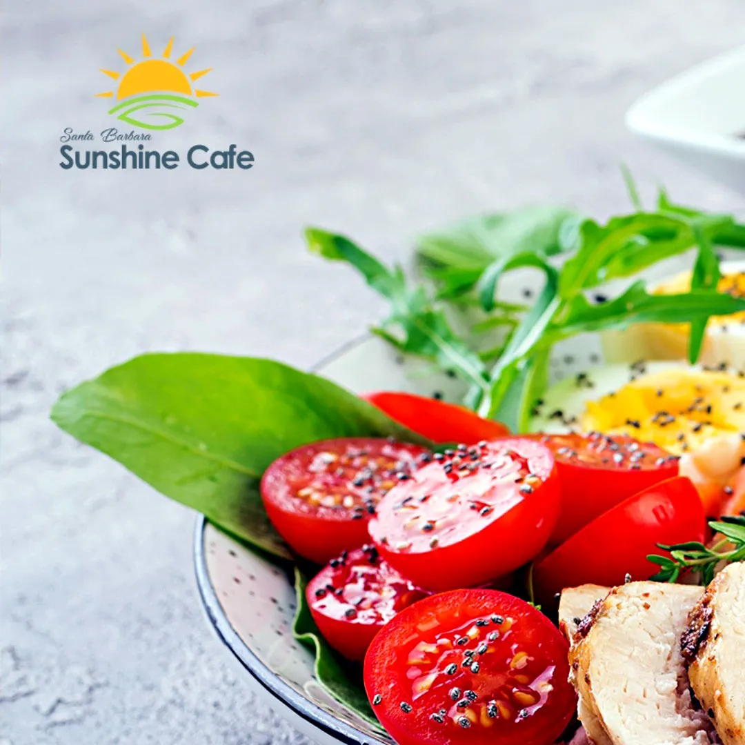 Cobb Salad with cherry tomatoes, spinach and arugula leaves, grilled chicken, hard-boiled eggs, and
black sesame seeds.
