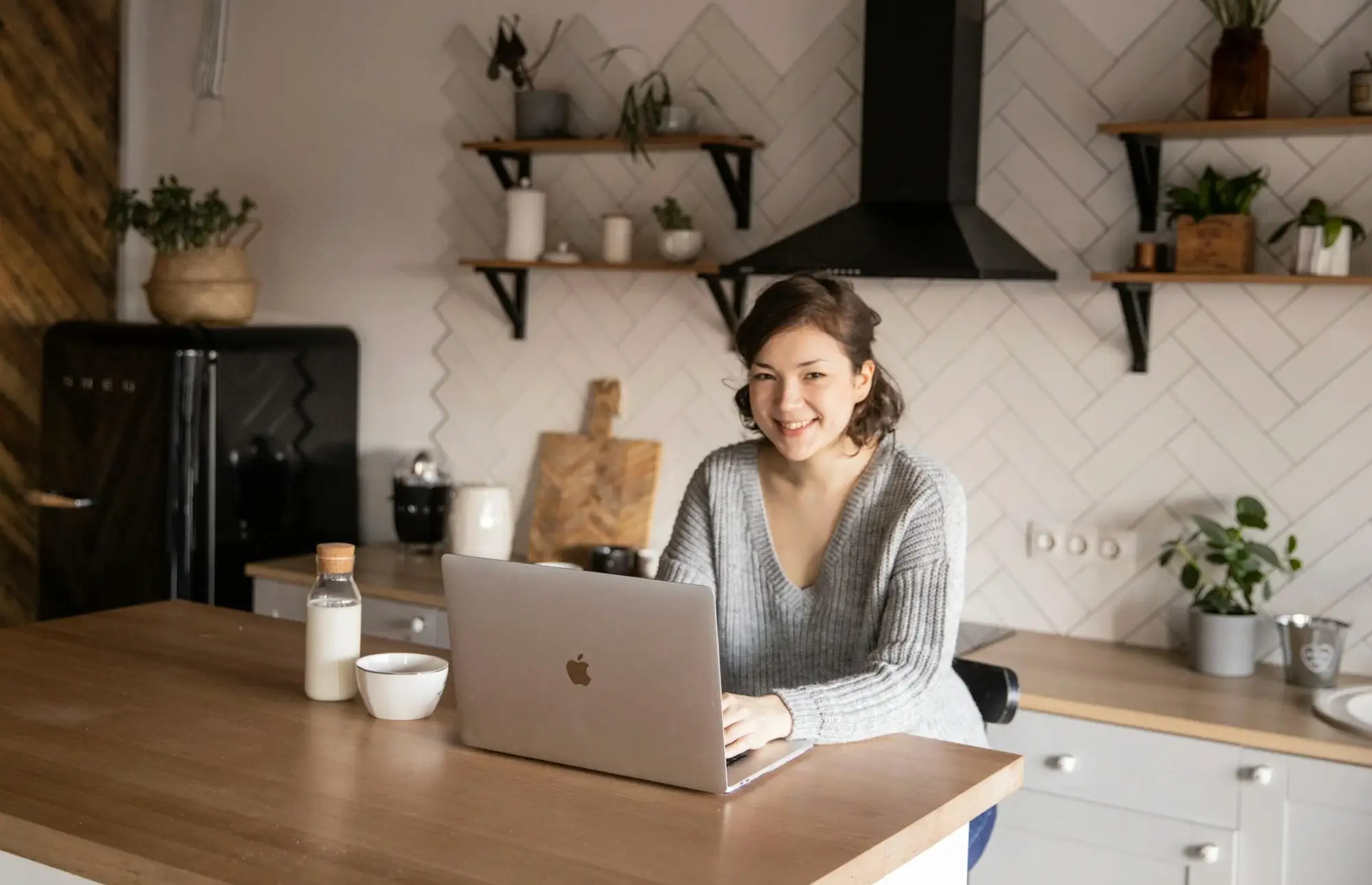 woman using laptop in kitchen