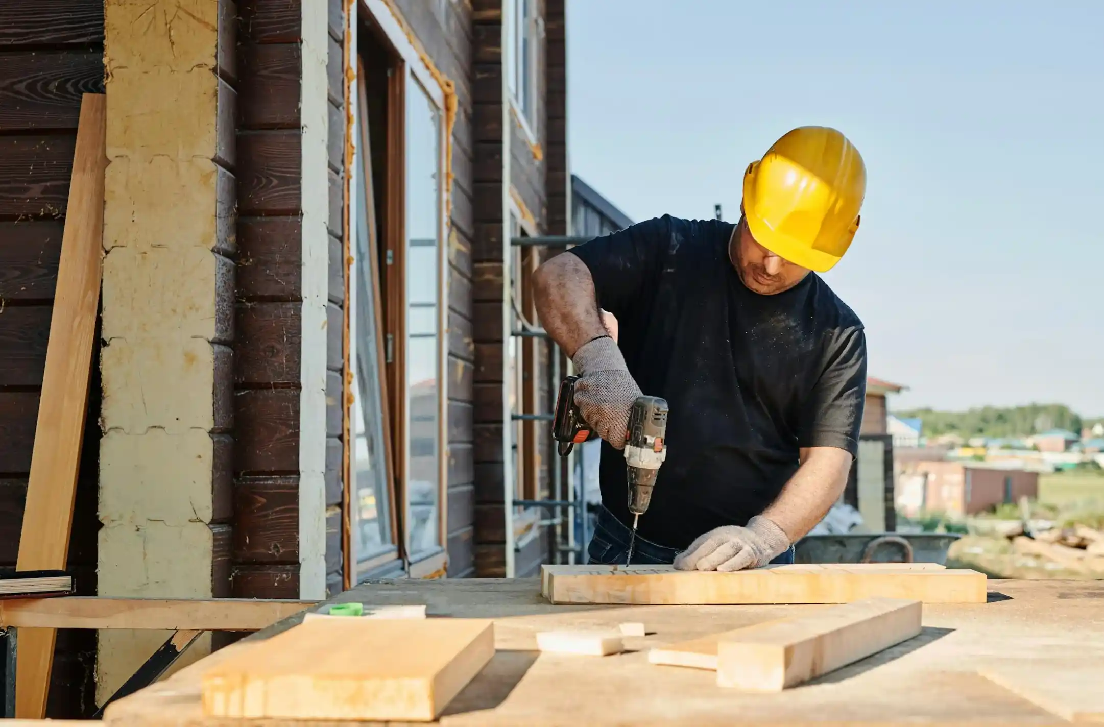 man in black shirt holding power tool