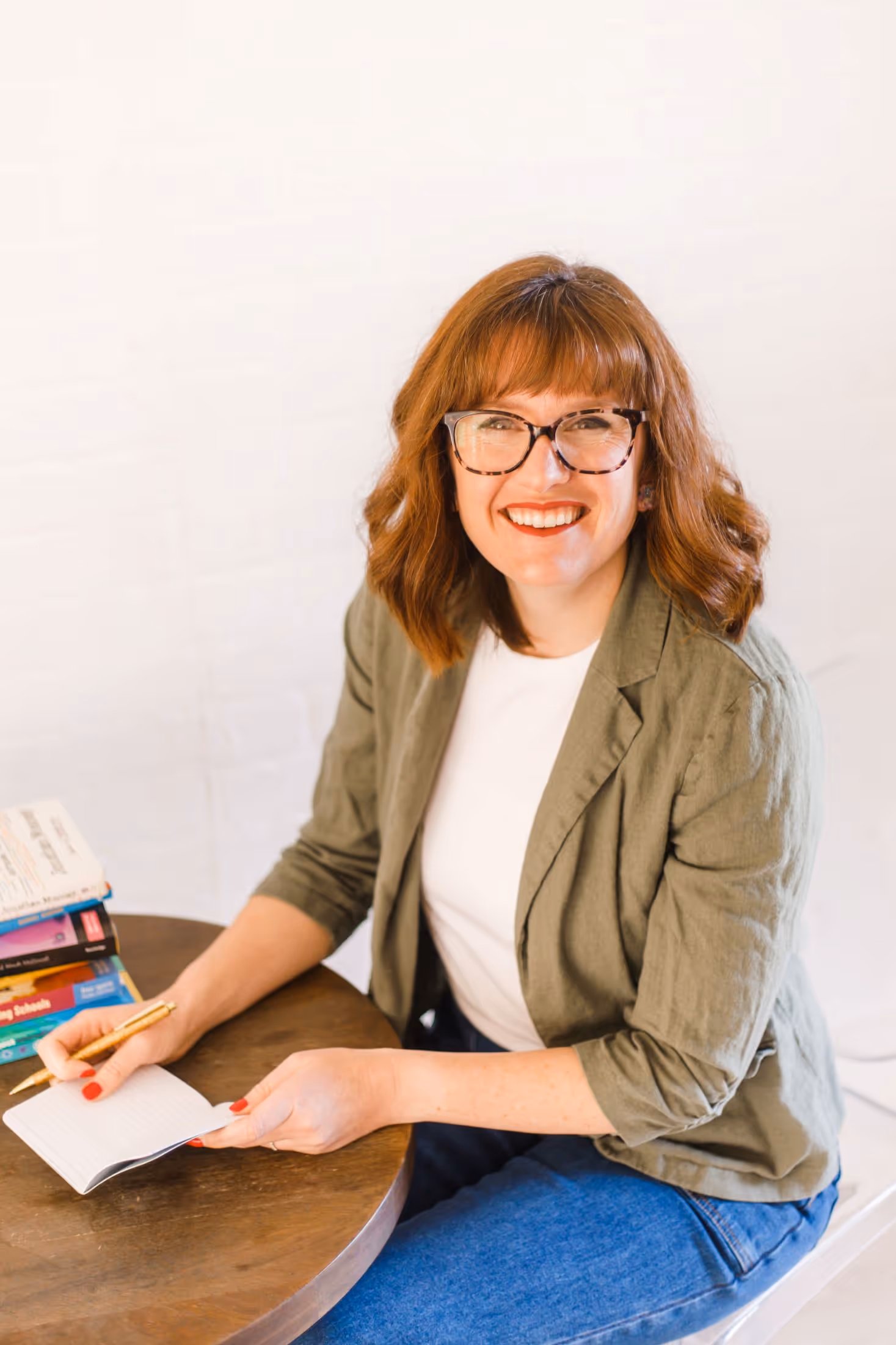 Amy Merenda, smiling at her desk while preparing professional staff development training.