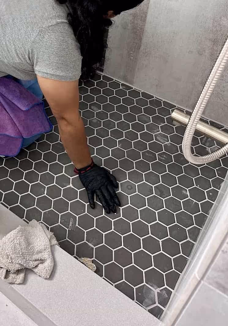 Cleaner deep cleaning a tiled shower floor