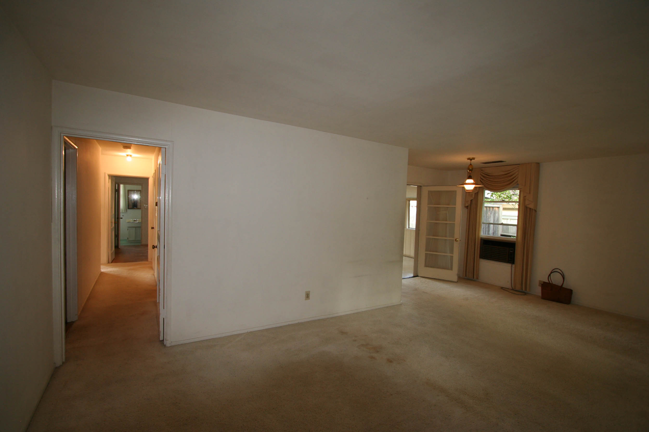 Before renovation the living-dining room was separate from the kitchen, and a narrow hallway led to the bedrooms