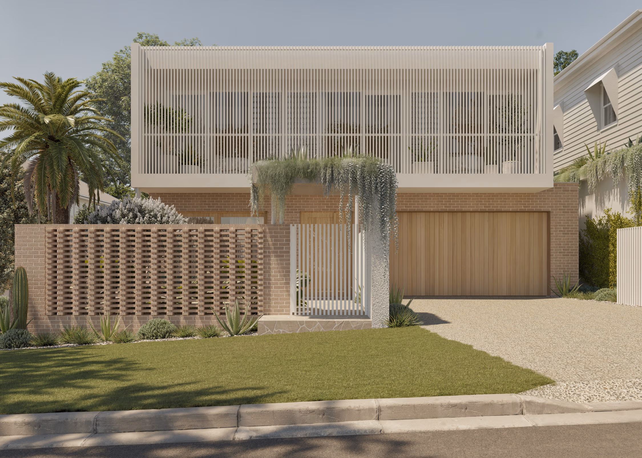 Modern two-story house with vertical slatted balcony, brick lower facade, wooden garage door, and green landscaping.