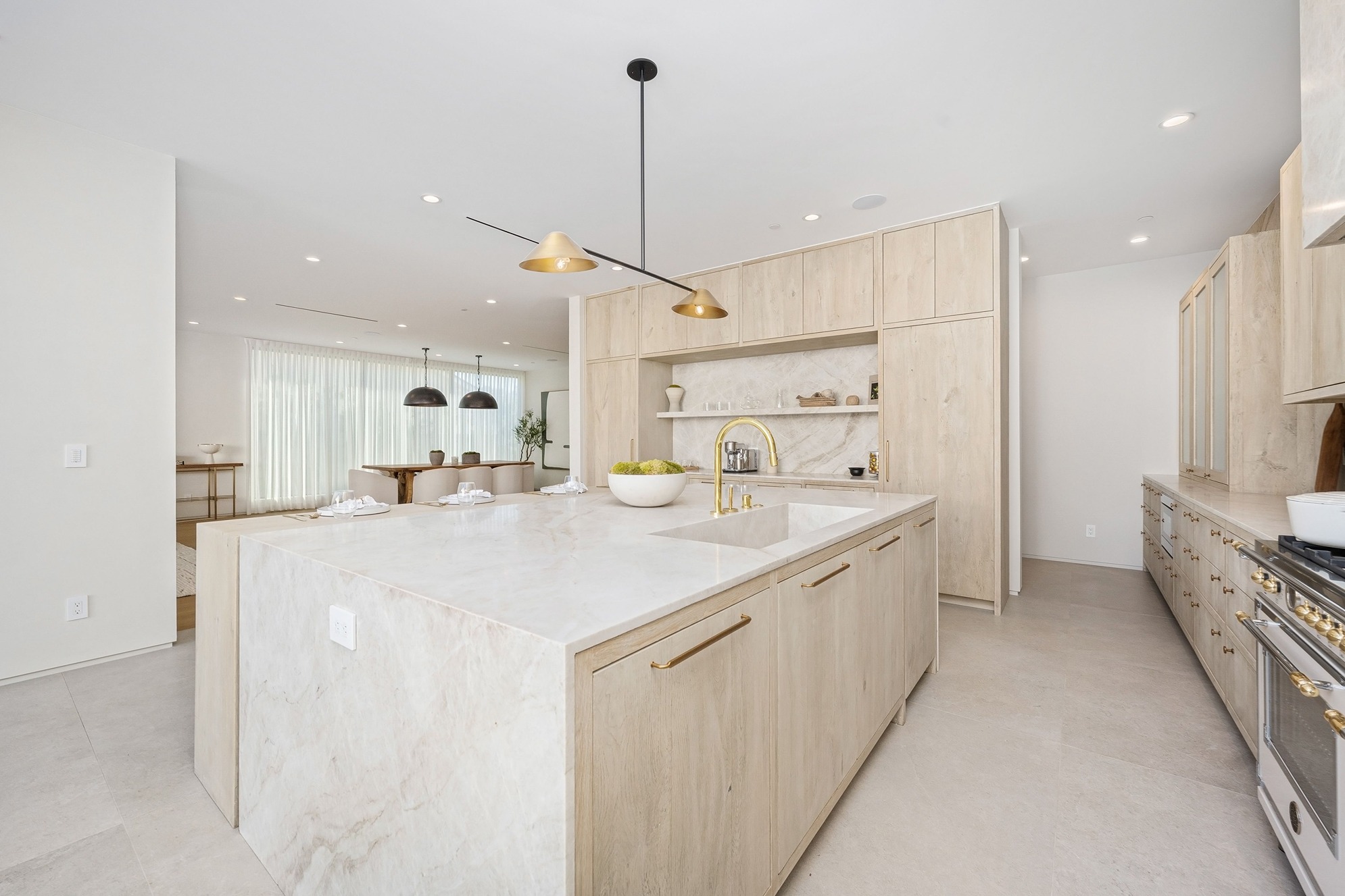White marble waterfall edge countertop with undermount sink installation in an Everett home