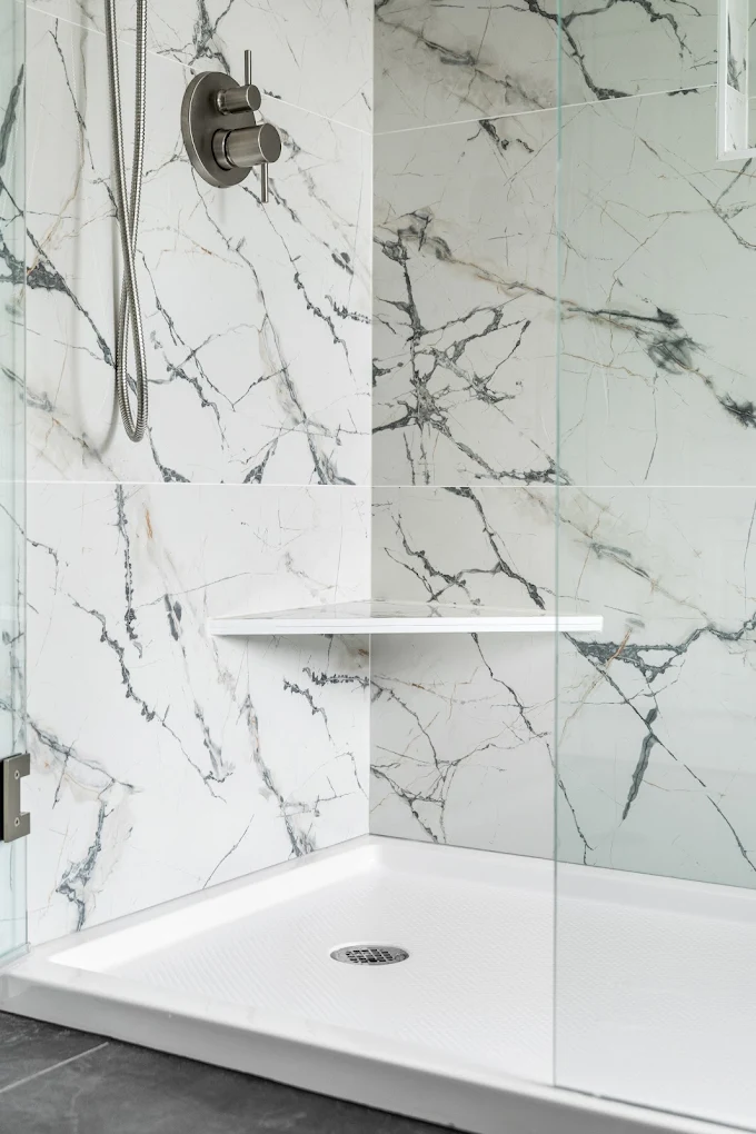 Low-maintenance white acrylic shower pan with matching seamless wall panels in Bothell, WA