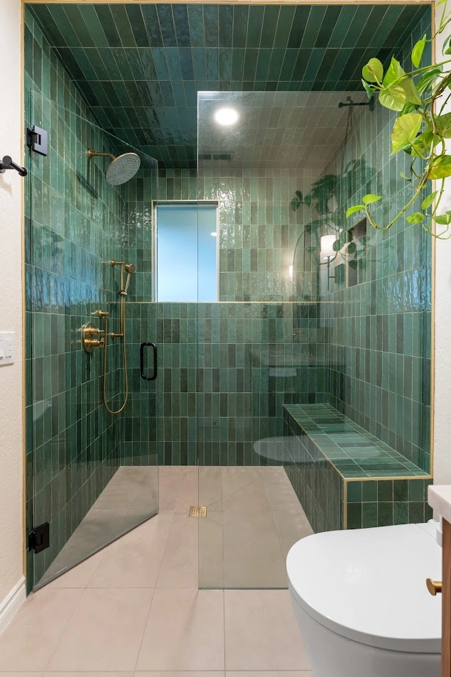 Custom tiled shower with a frameless glass door enclosure and brushed nickel fixtures in Bothell, WA