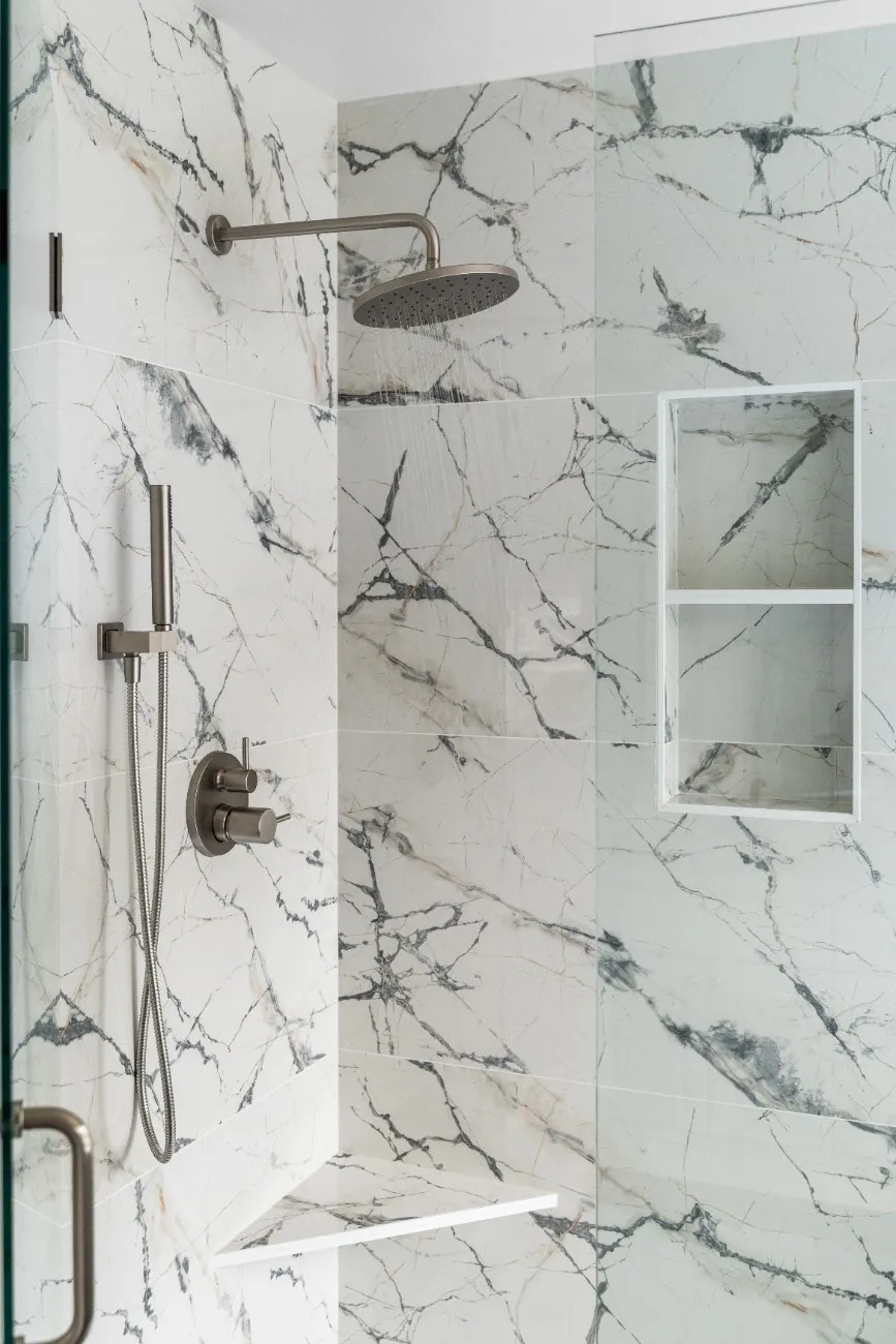 Shower fixtures and mini shelf installed on a ceramic-tiled wall in a Bothell bathroom