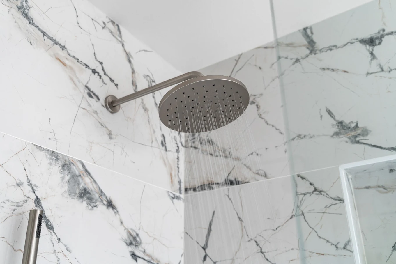 A showerhead surrounded by ceramic tile installed by Bothell bathroom contractor 