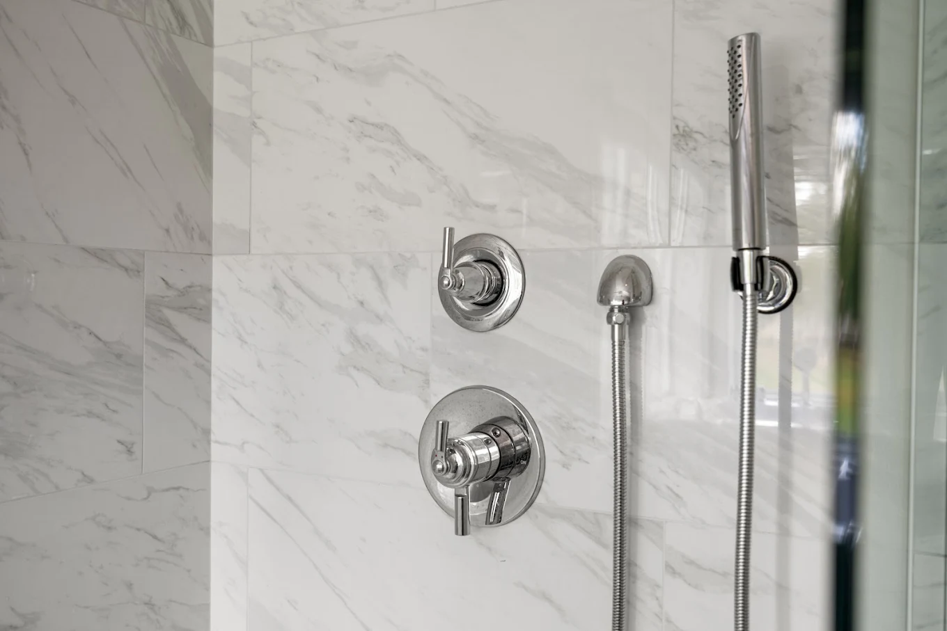 Shower fixtures fixed on large format tile walls in a Bothell bathroom