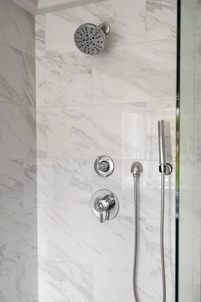 Shower faucets installed in a tiled wall in a Bothell bathroom