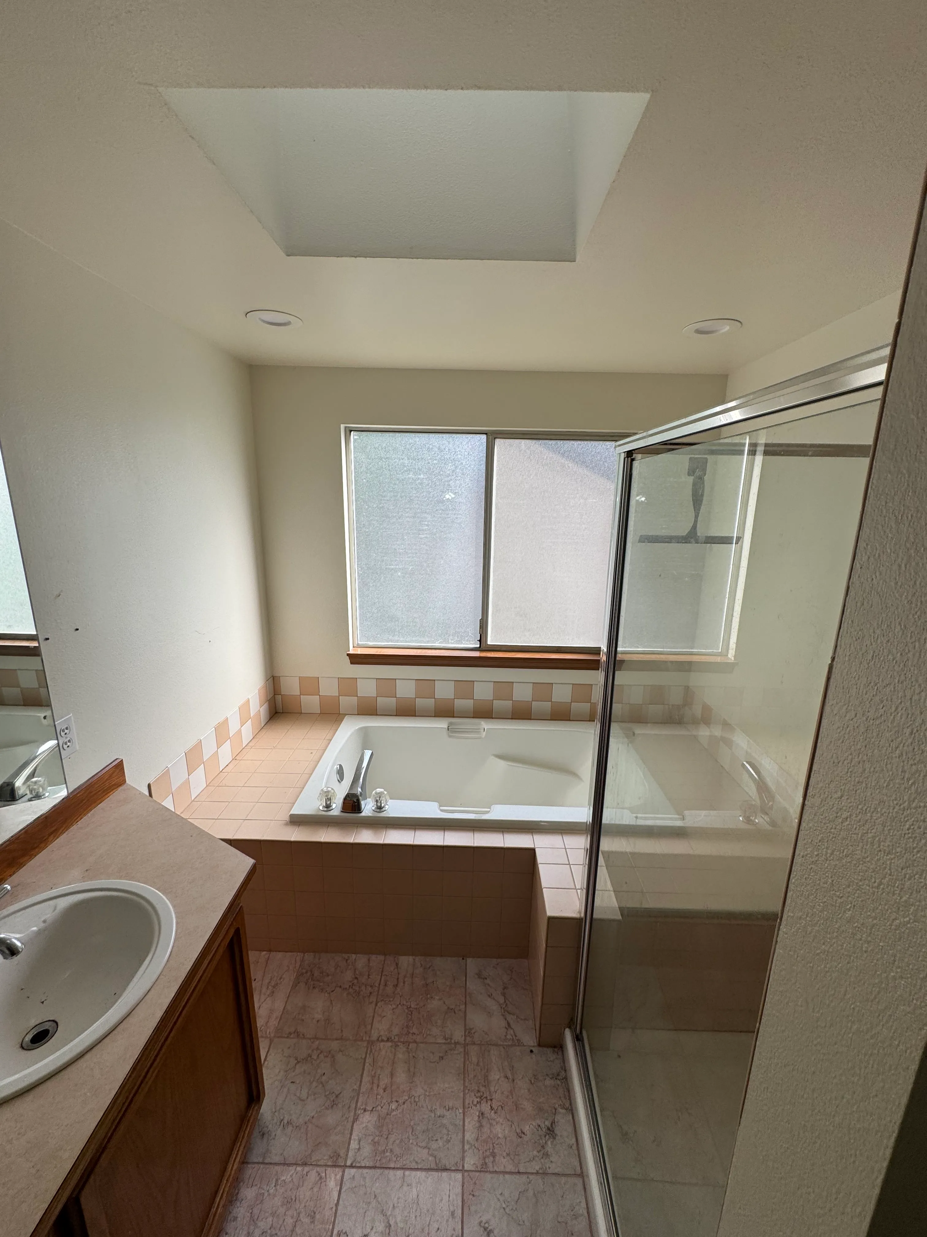 A walk-in shower and accessible bathtub in a Bothell bathroom