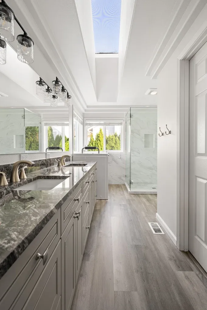 A double vanity sink and ADA bathtub near a walk-in shower in Bothell