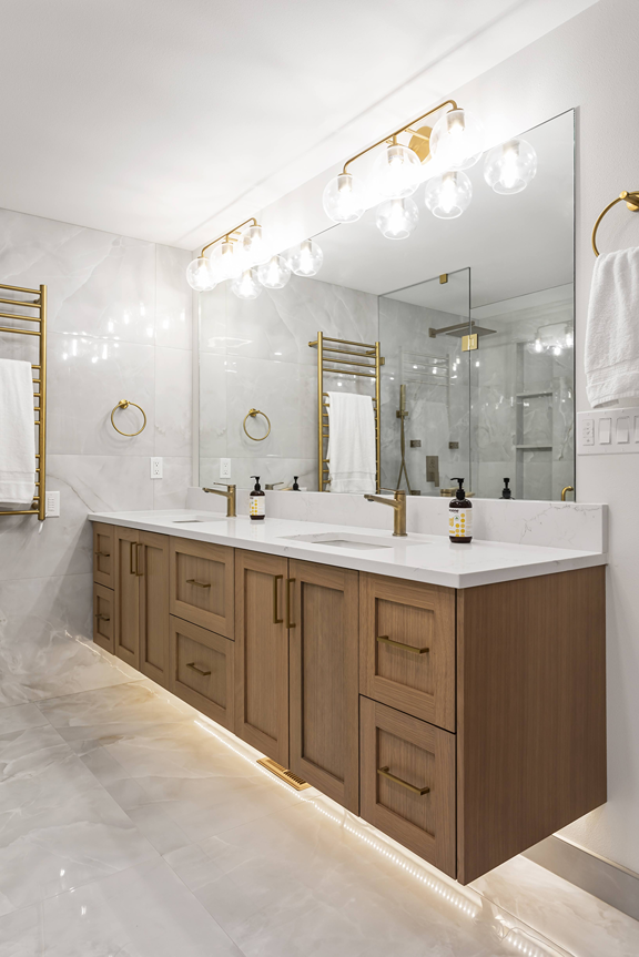 Custom built-in bathroom cabinetry fitted to a non-standard wall in a Bothell home