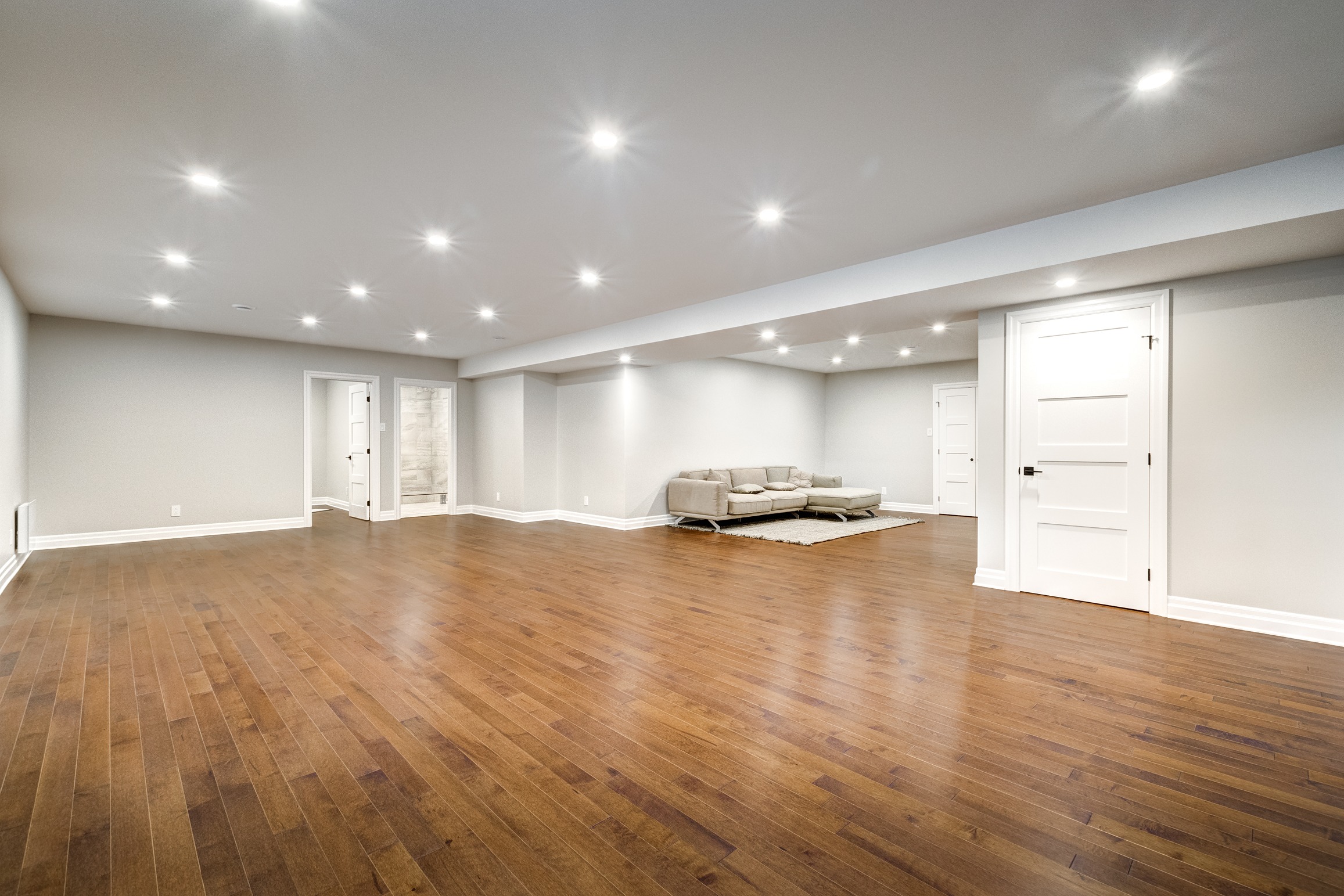Large finished basement with recessed ceiling lights, light gray walls, Waterproof flooring, 