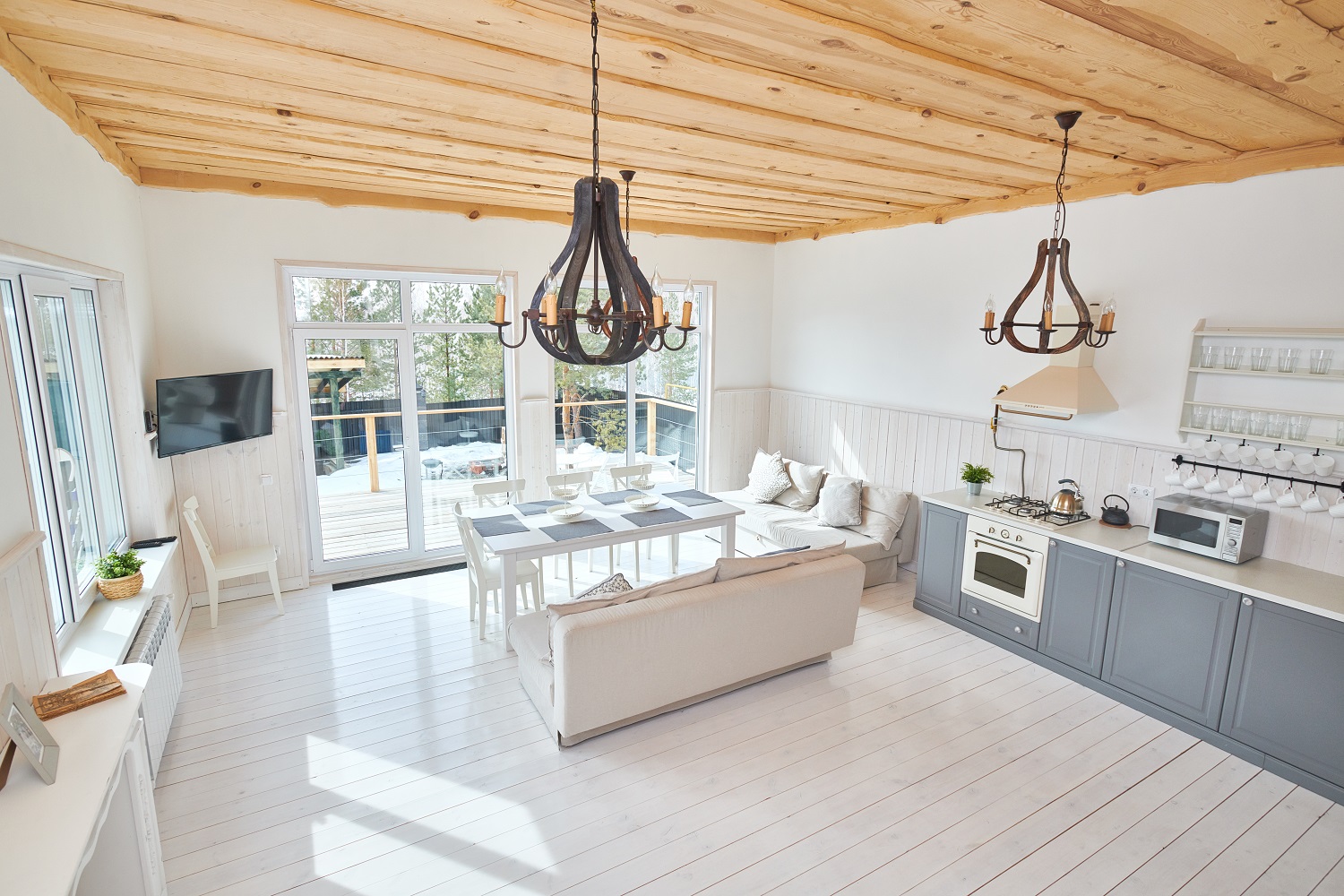 Open concept kitchen with shiplap ceiling and pendant lighting in mountain contemporary home  