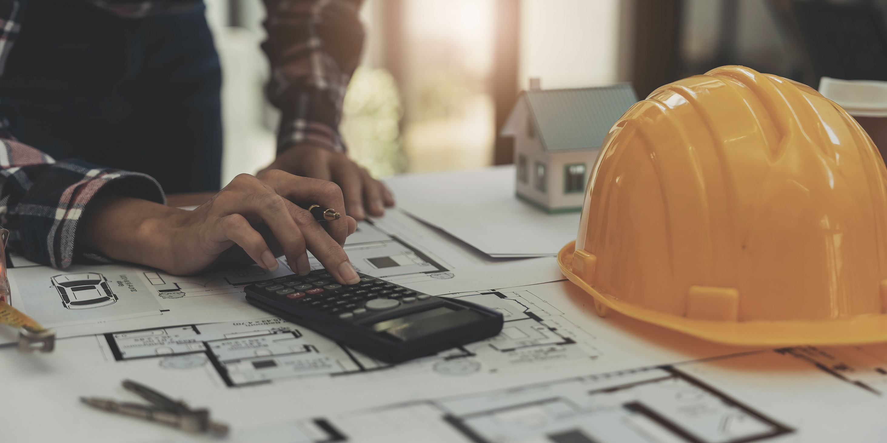 Contractor reviewing whole home remodel cost estimates at a job site