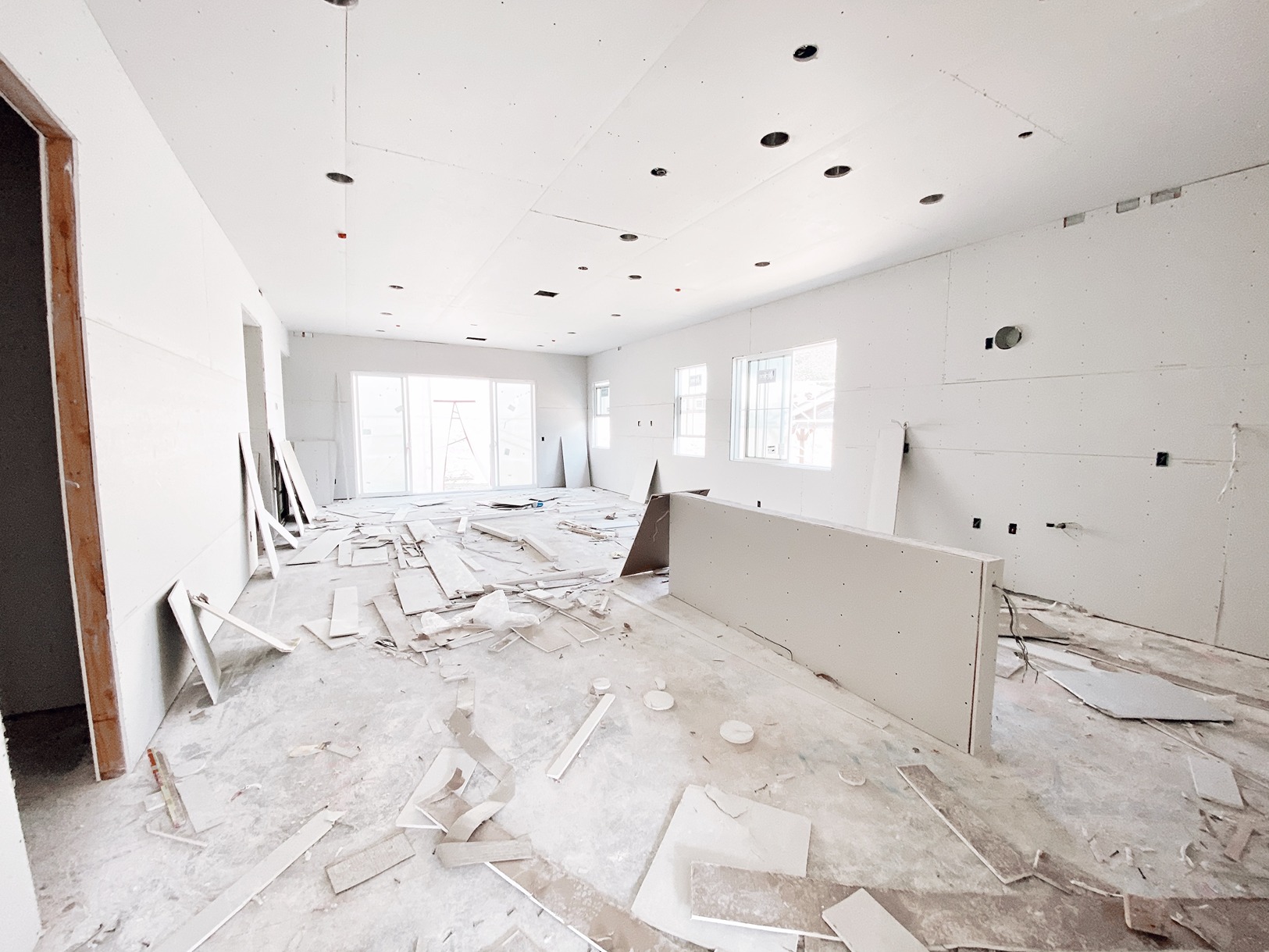 Full gut renovation in progress with demolished flooring and exposed drywall